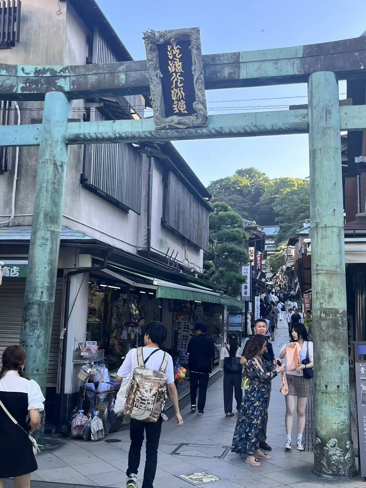 青铜鸟居下的江岛参道与来往行人
